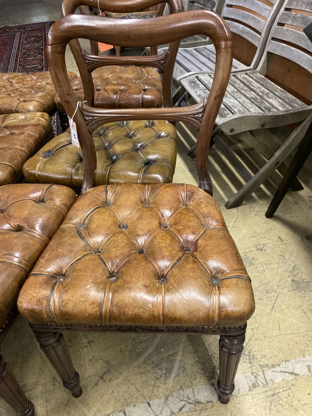 A set of six early Victorian mahogany dining chairs, with buttoned leather seats